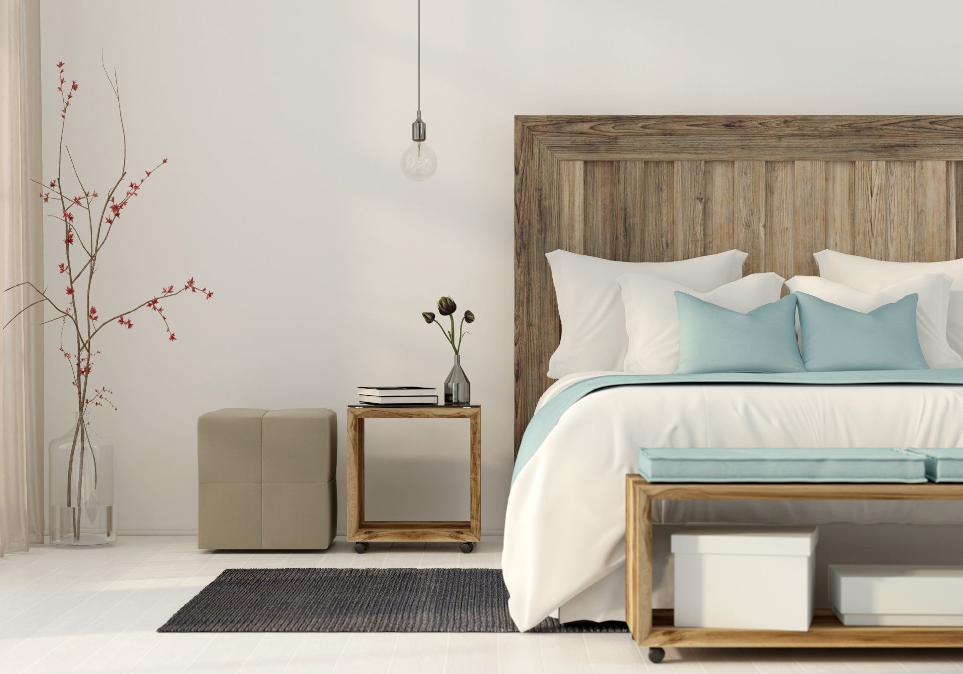 Minimalist bedroom with wood bed, white bedding, teal pillows, and a small side table beside a vase of branches