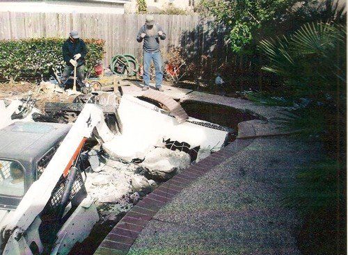 Swimming Pool removal services — Construction Truck Destructing the Pool in Houston, TX