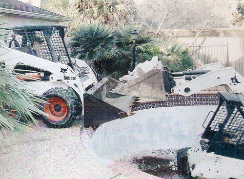 Truck Loader Passing the Pool Debris to Other Truck in Houston, TX