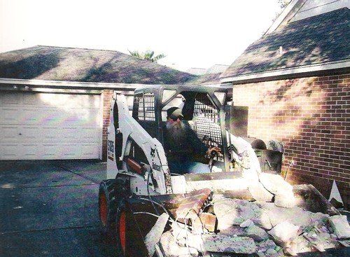 Commercial Services — Truck Front Loader Carrying Debris in Houston, TX