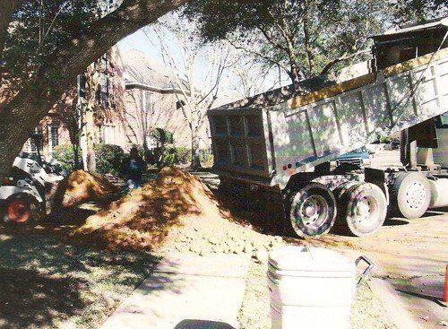 Swimming Pool Removal Services — Truck Loader Loaded with Soils in Houston, TX