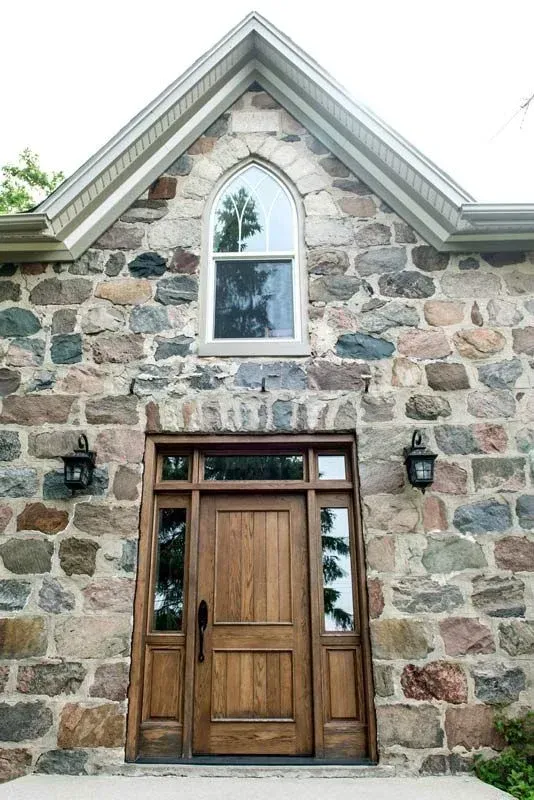 A stone building with a wooden door and a window