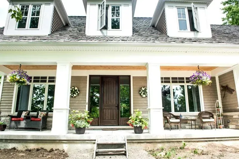 The front of a house with a porch and stairs