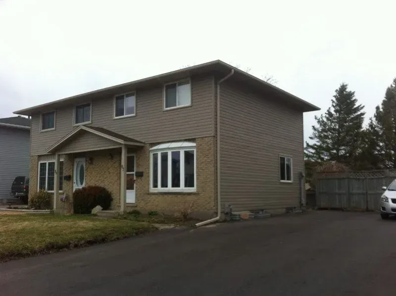 A large house with a car parked in front of it.