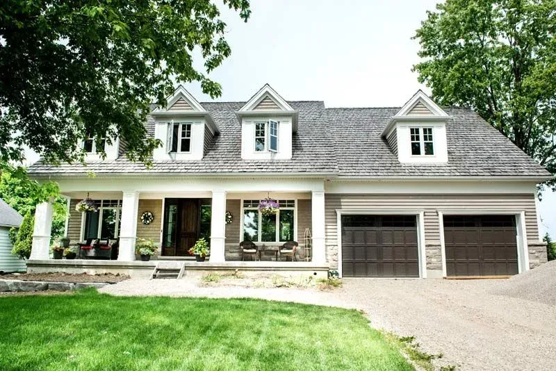 A large house with two garages and a large porch