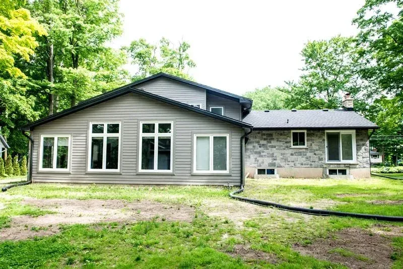 The back of a house with a lot of windows