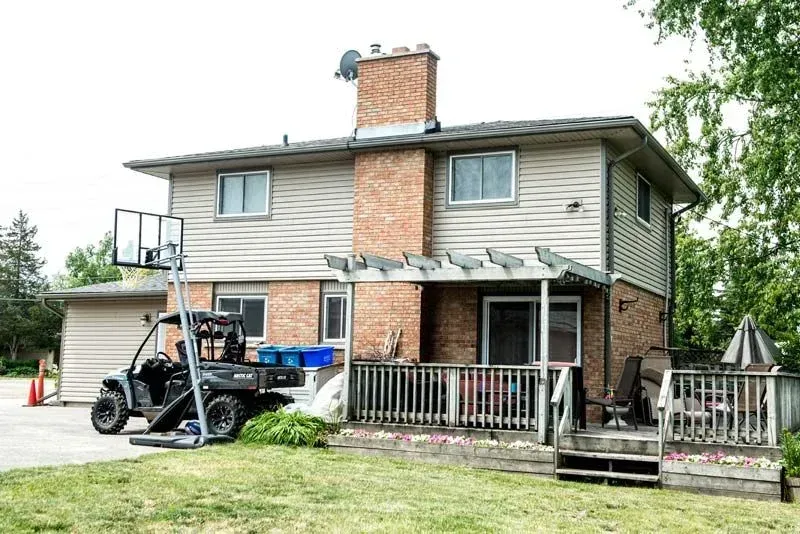 A house with a pickup truck parked in front of it.