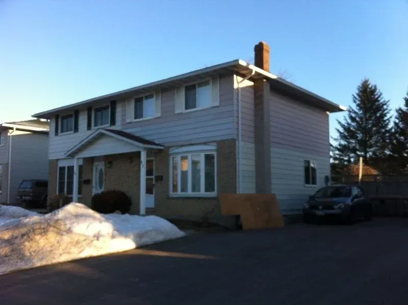 A house with a car parked in front of it