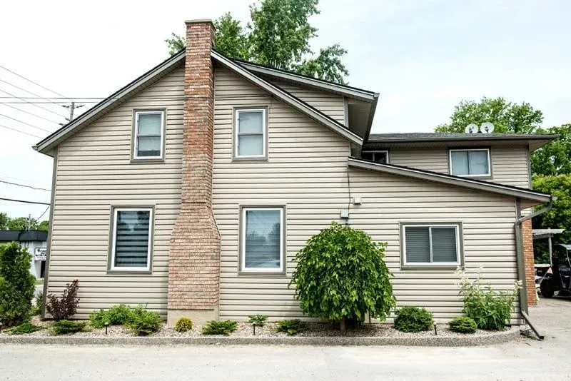 A house with a chimney on the side of it