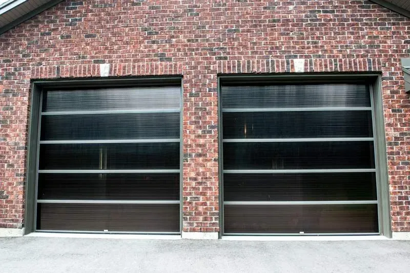 A brick building with two garage doors on it