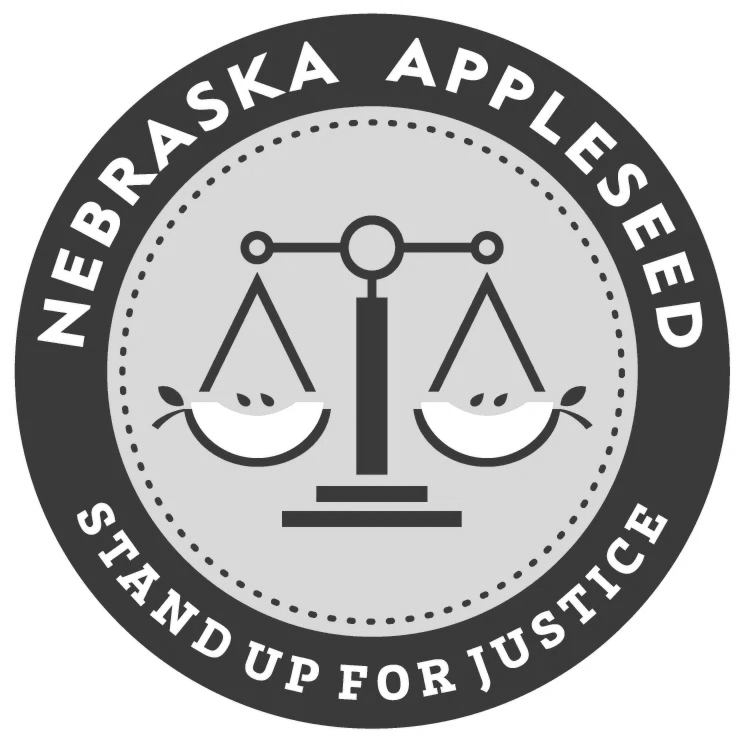 Nebraska Appleseed logo with balance scales and the words “Stand Up for Justice”