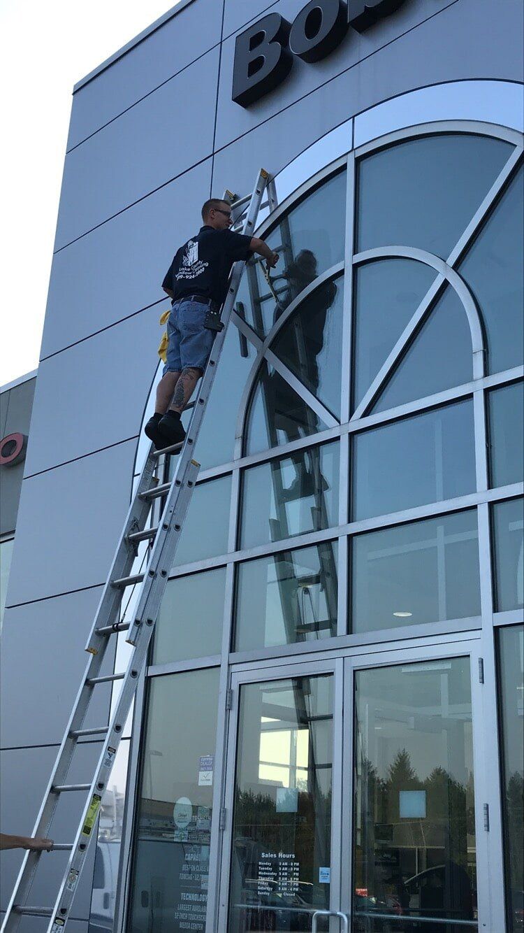 Cleaning Services — Man in Stairs Cleaning Window Side in Crown Point, IN