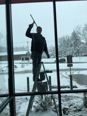 House Cleaning — Man Cleaning The Window in Crown Point, IN
