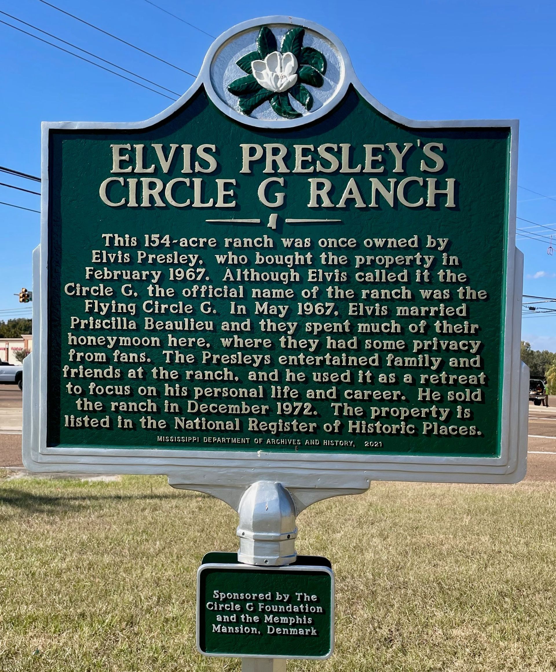 A green sign that says elvis presley 's circle g ranch
