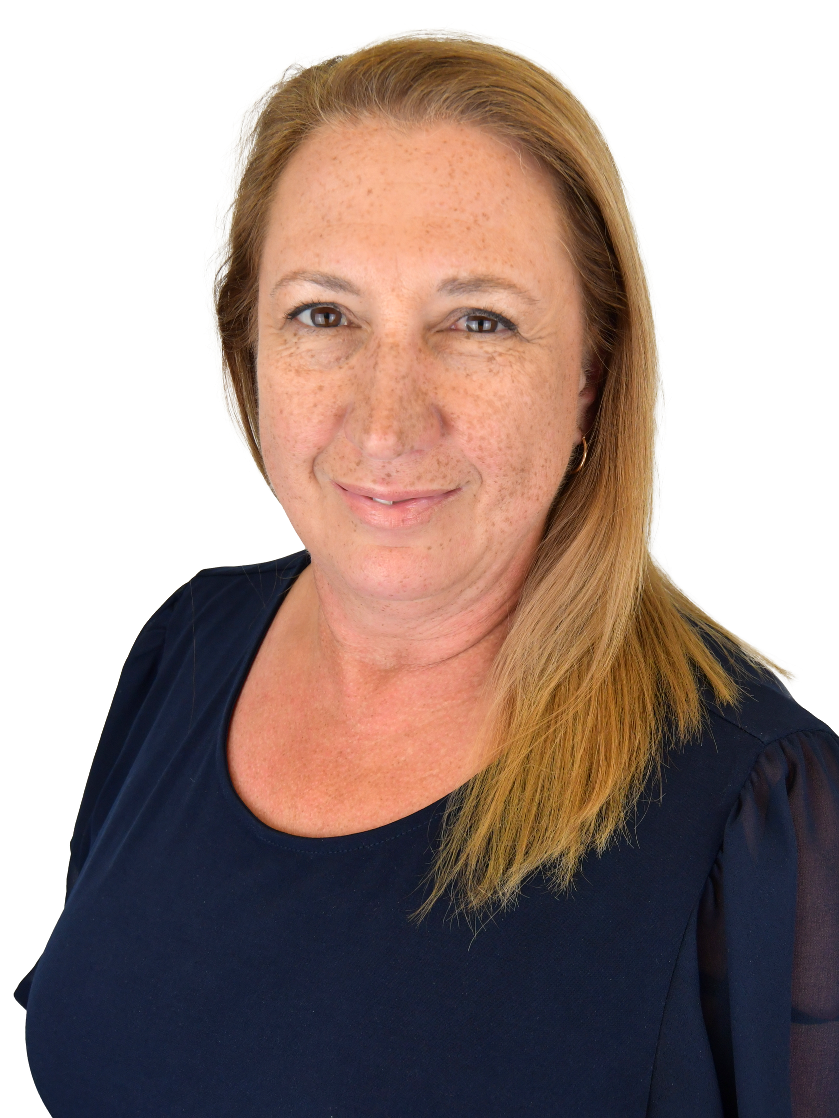 Woman with long blonde hair smiling in a navy blue top, looking at the viewer.