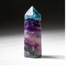 A tall, colorful fluorite crystal tower with layers of purple, blue, and clear.