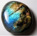 Smooth, oval-shaped labradorite stone with blue, gold, and teal iridescent flashes.