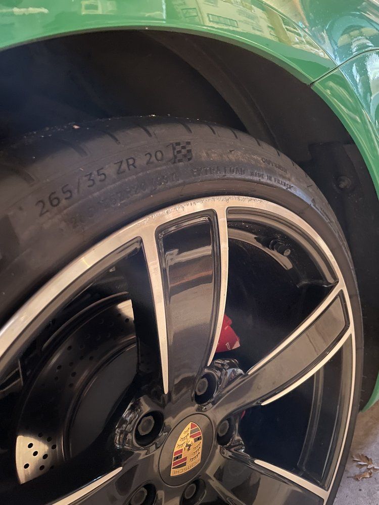A close up of a tire on a green car