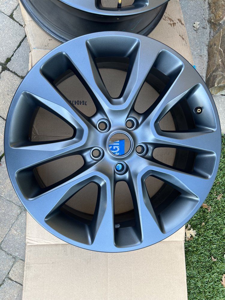 A pair of wheels are sitting on top of a cardboard box.