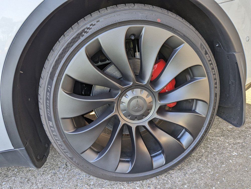 A close up of a tesla model 3 wheel