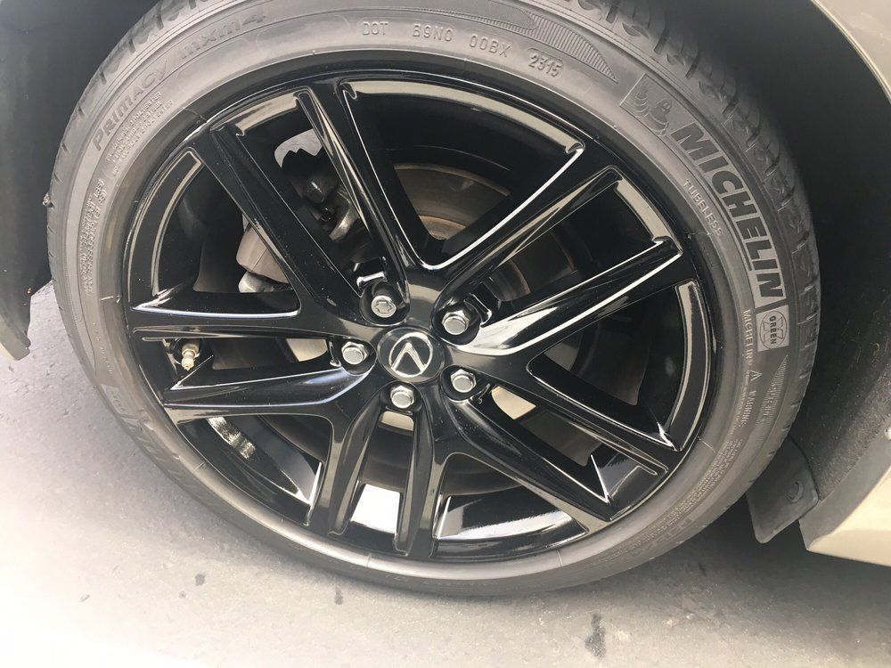 A close up of a car wheel with a michelin tire on it.