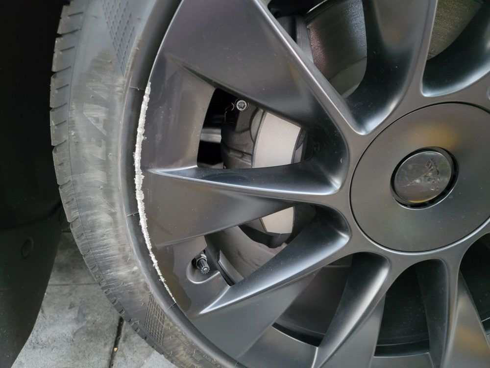 A close up of a car wheel with a tire on it