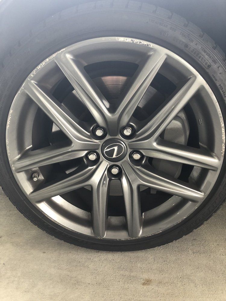 A close up of a car wheel with a logo on it