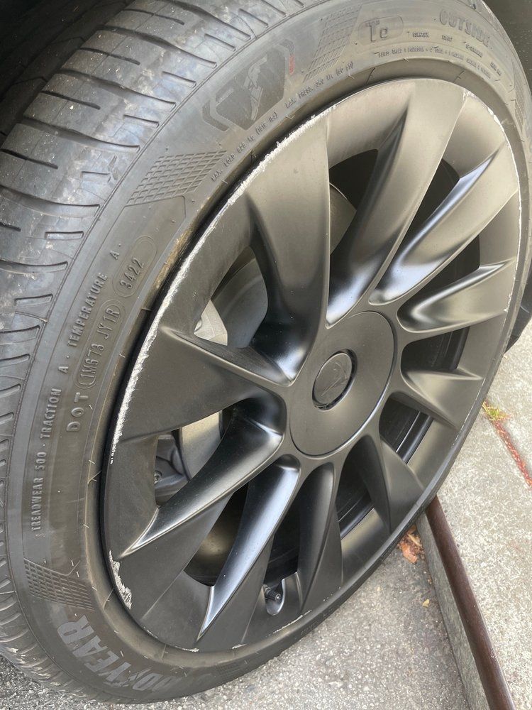 A close up of a black tire on a car