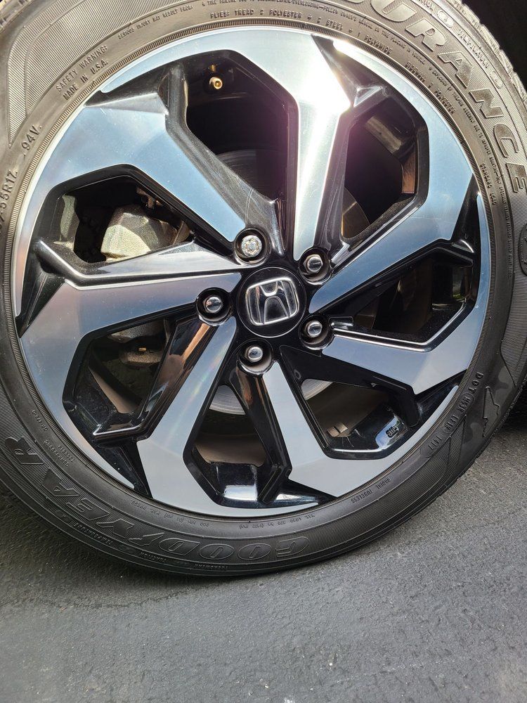 A close up of a car wheel with a tire on it.
