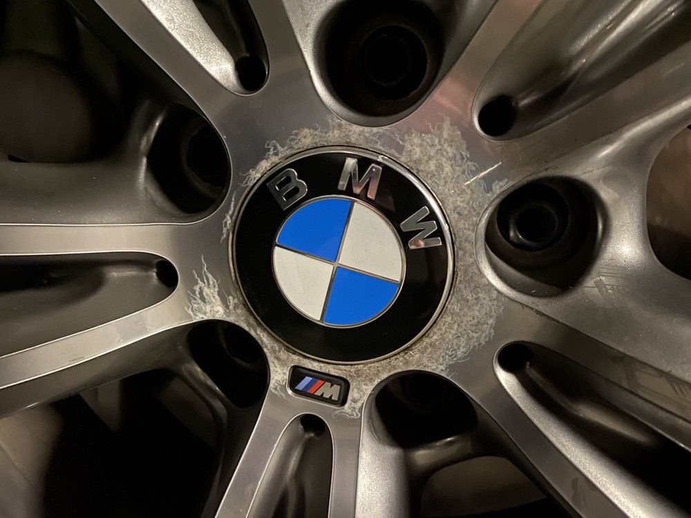 A close up of a bmw wheel with a bmw logo on it