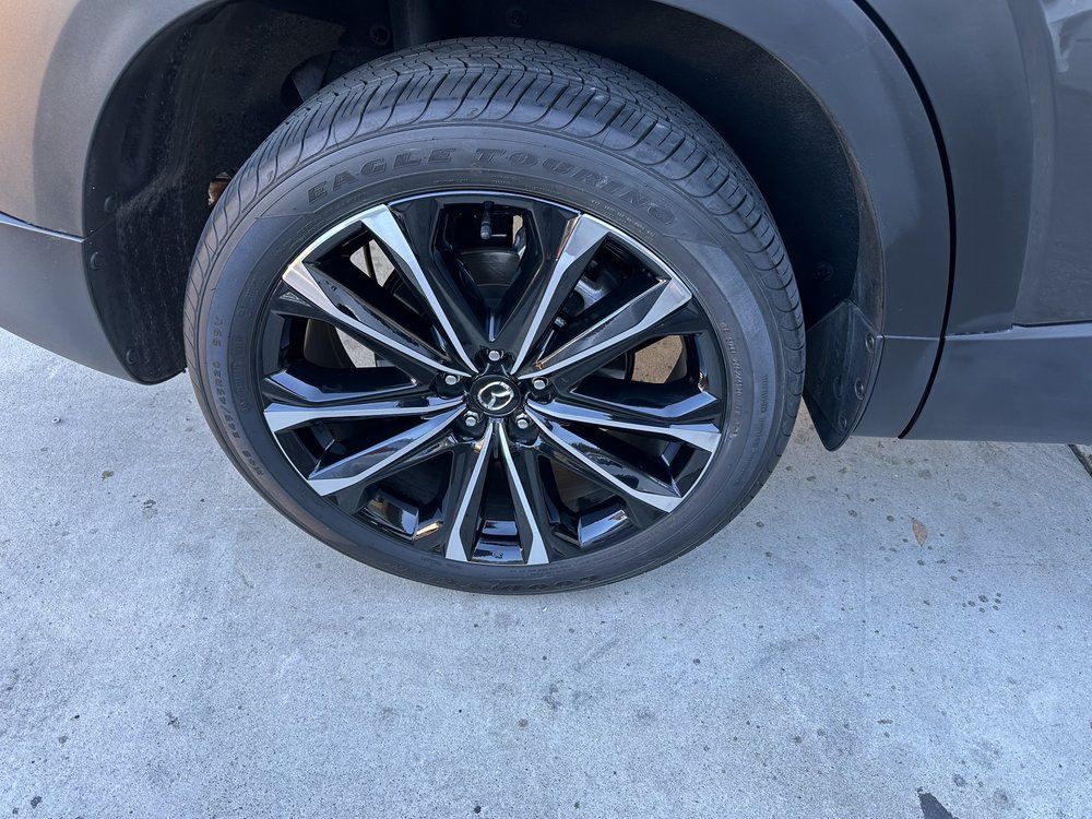 A close up of a car tire on a concrete surface.