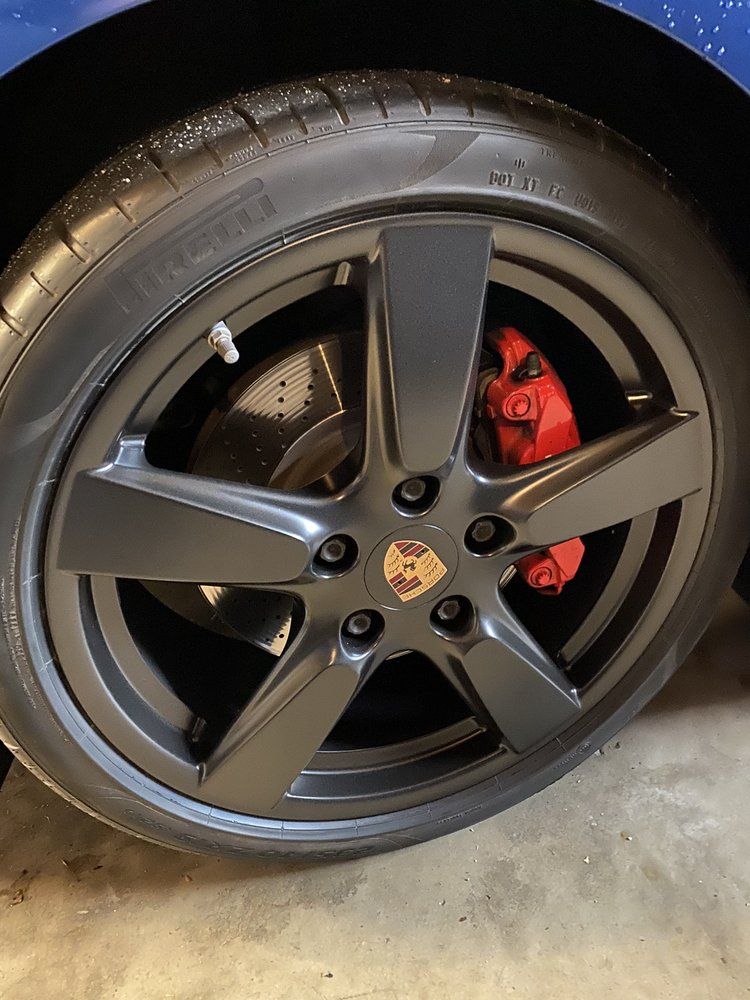 A close up of a car wheel with a tire on it