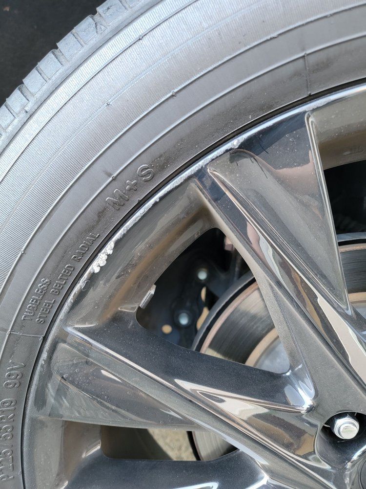A close up of a tire on a car wheel