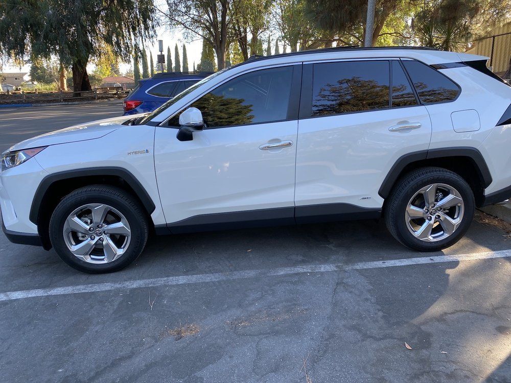 A white suv is parked in a parking lot.
