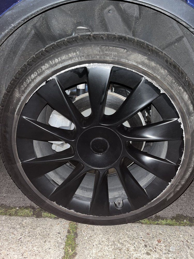 A close up of a black wheel on a car