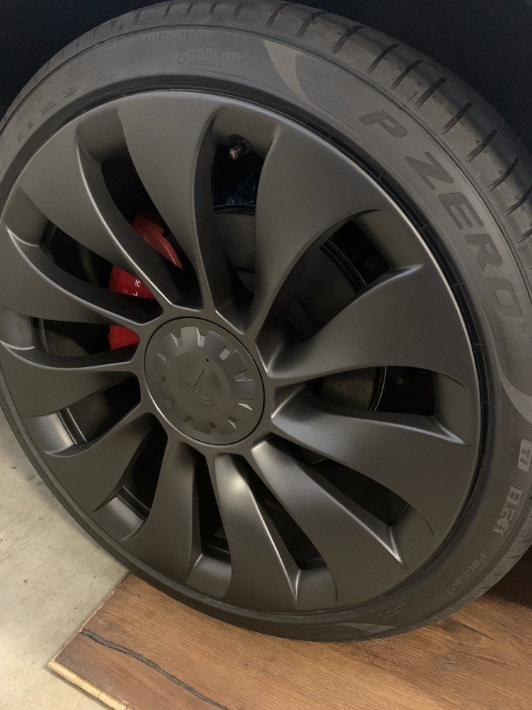 A close up of a tire on a tesla model 3