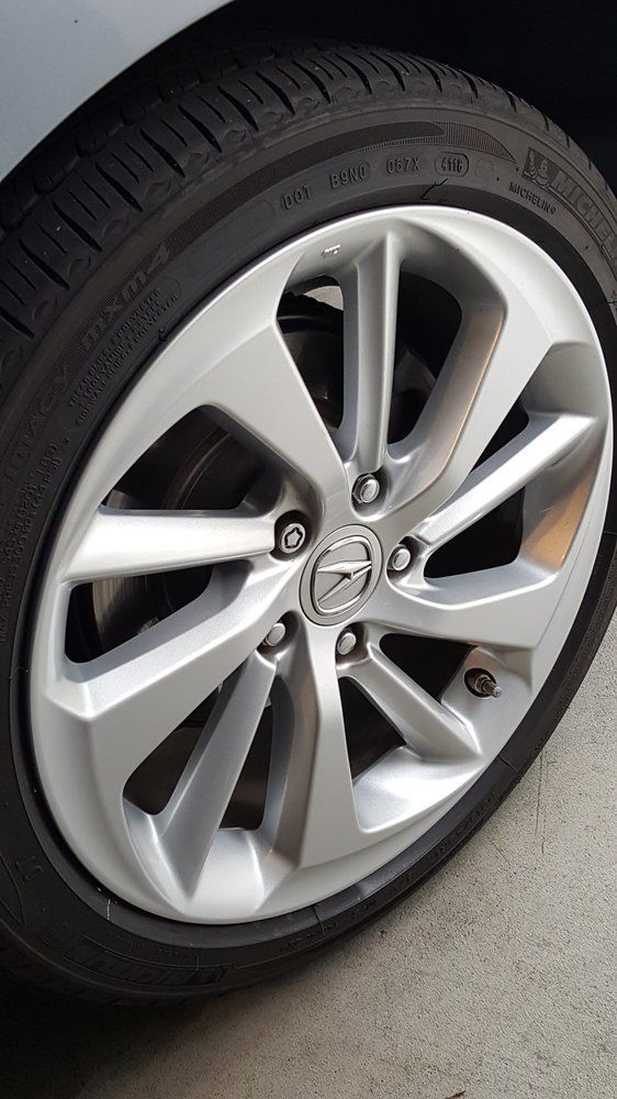 A close up of a car wheel with a tire on it