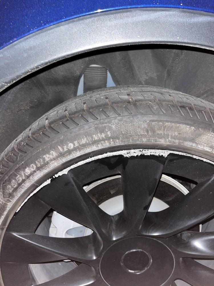 A close up of a tire on a blue car