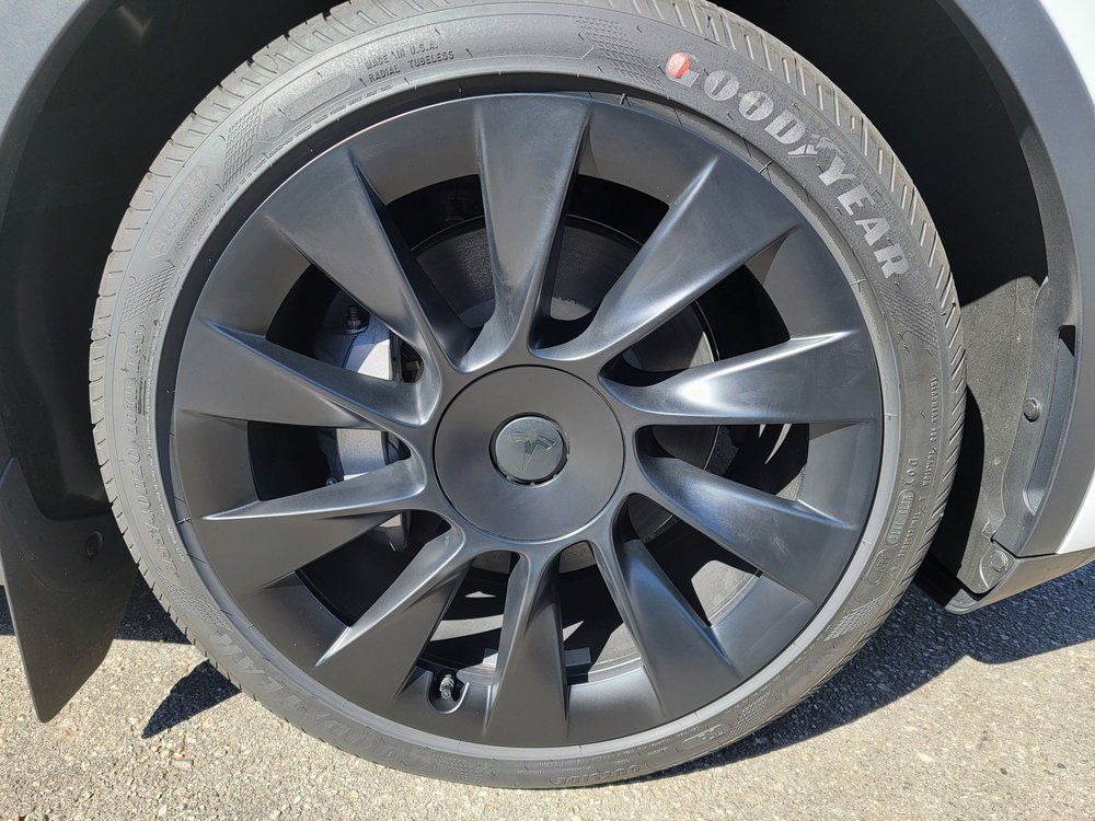 A close up of a car wheel with a goodyear tire on it.