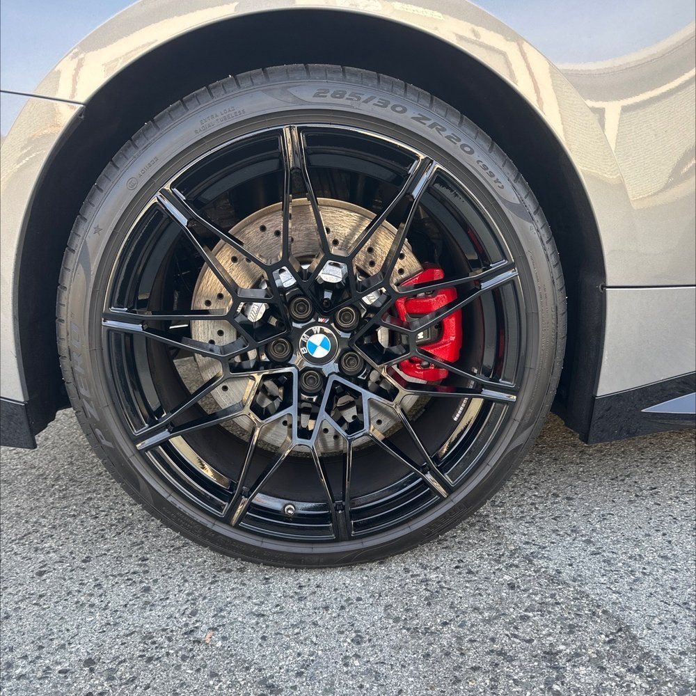 A close up of a car wheel with a bmw logo on it