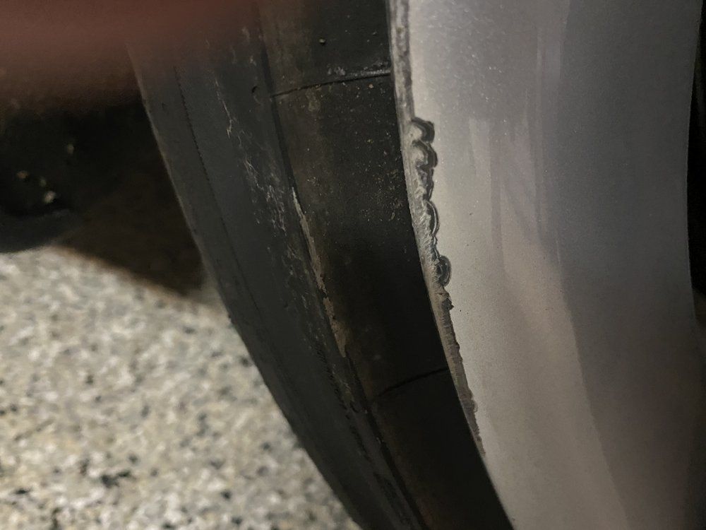 A close up of a tire on a car wheel.