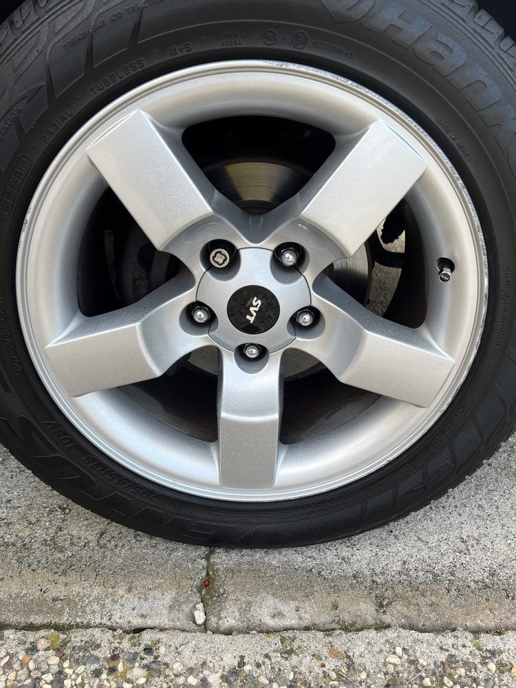 A close up of a car wheel with a tire on it