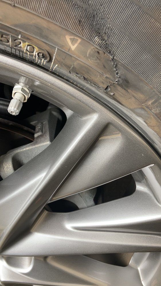 A close up of a tire on a car wheel.