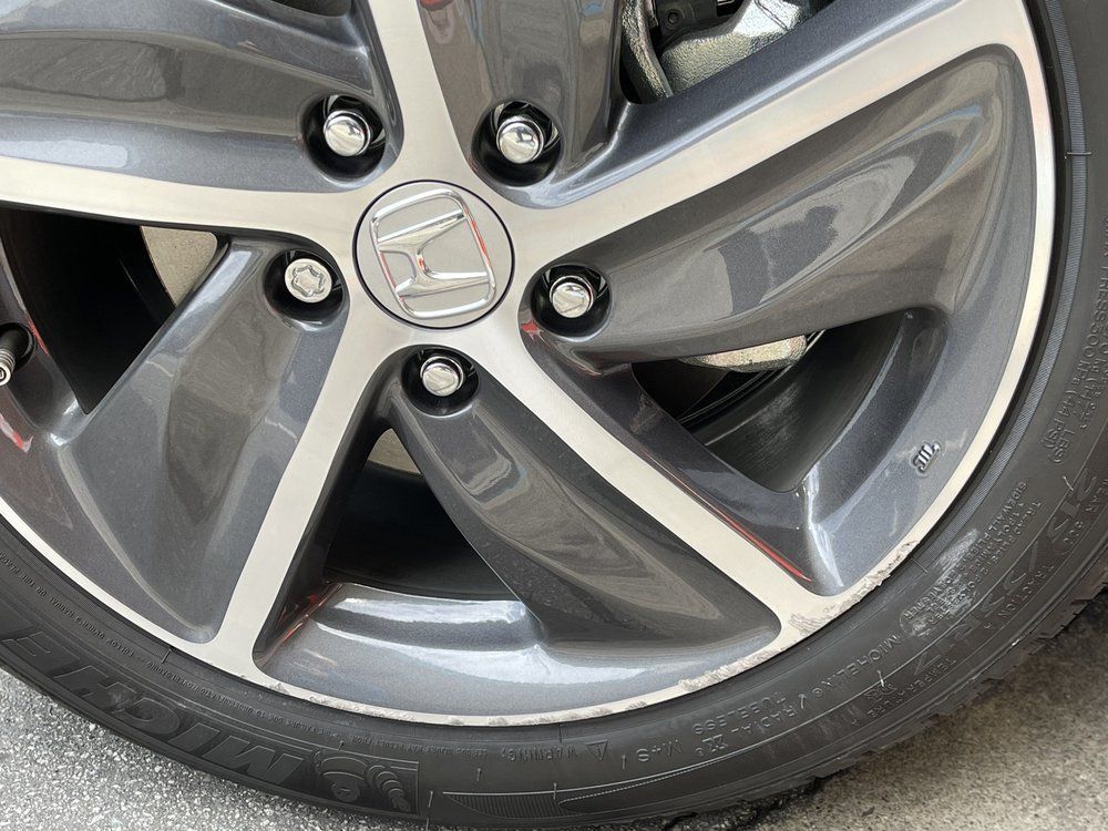 A close up of a car wheel with a tire on it.