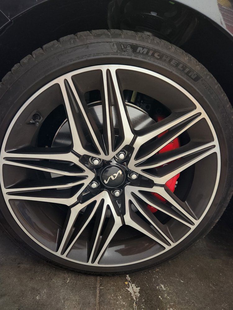 A close up of a car wheel with a michelin tire