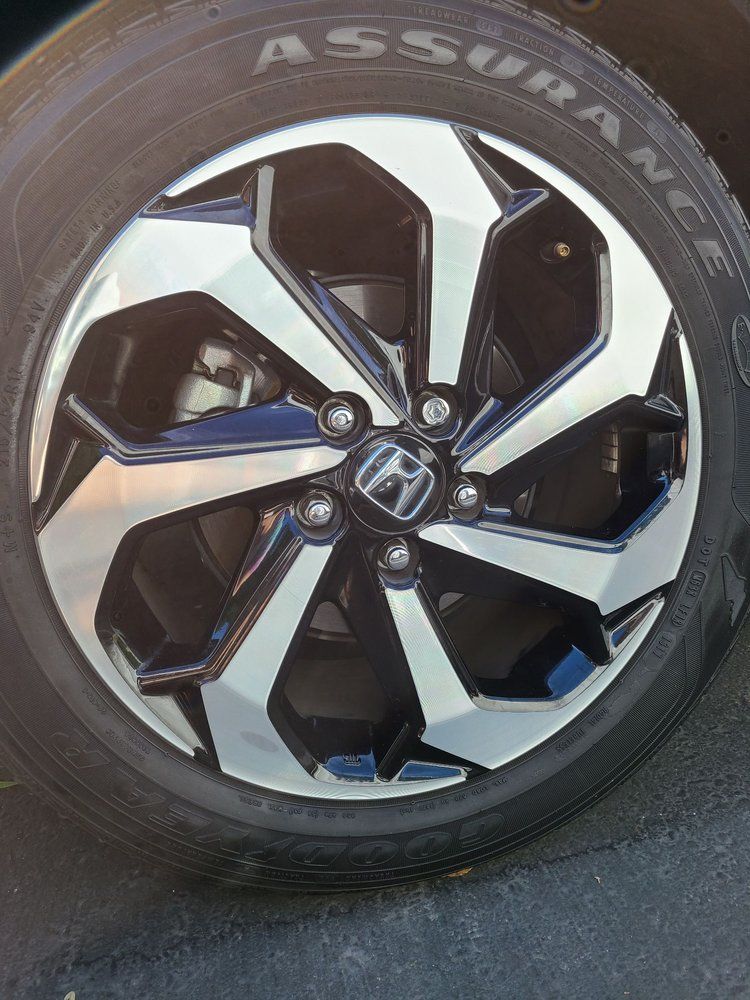 A close up of a car wheel with a tire on it.