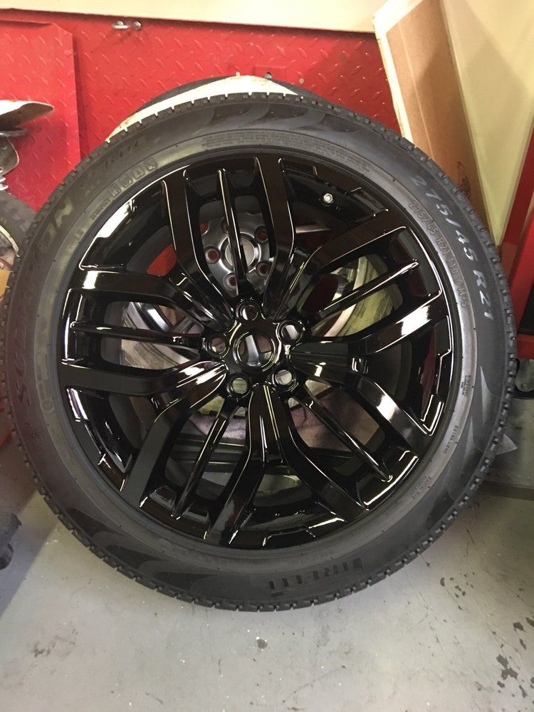 A close up of a black tire on a black rim