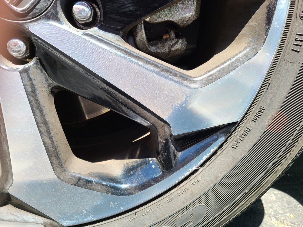 A close up of a car wheel with a tire on it.