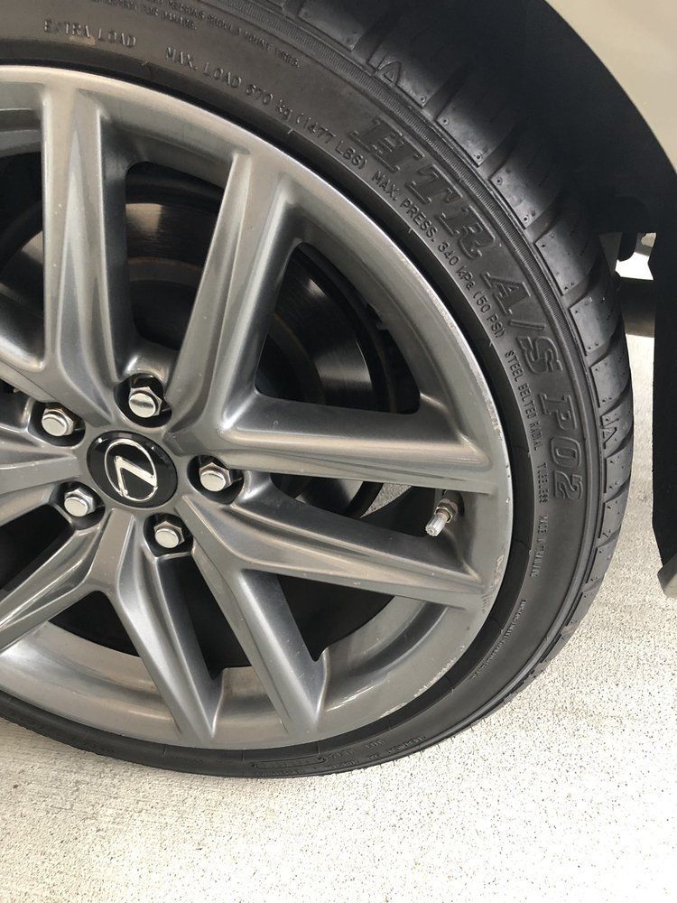 A close up of a tire on a lexus car