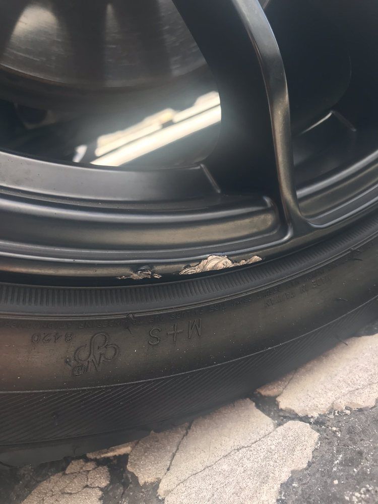 A close up of a tire on a car wheel.